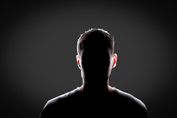 dark backlight shadow silhouette of male person, incognito unknown profile - obrazy, fototapety, plakaty