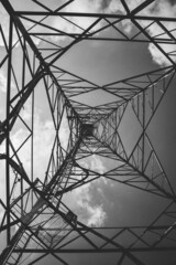 Grayscale shot inside an electricity transmission tower