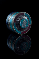 Vertical shot of a Greek round jewelry box isolated on black background