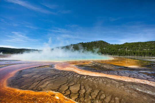 Beautiful shot of a natural geiser steaming in the daytime.