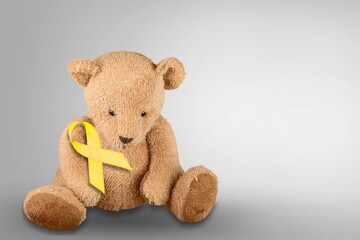 International Childhood Cancer Awareness month, Children toy with golden Ribbon for supporting