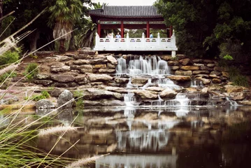 Poster View of waterfall and its reflection on water at Chang Lai Yuan Chinese gardens, Blacktown, Sydney, © Rani Matta/Wirestock