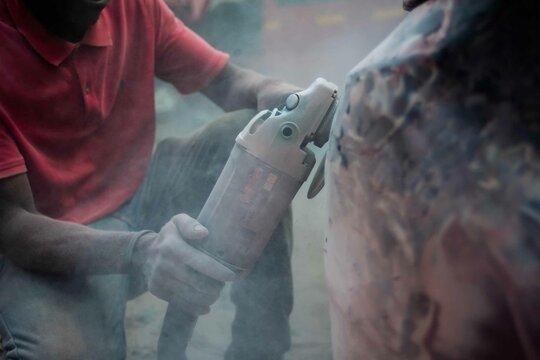 African Auto Bodyworks,  Welding a Car in Africa,  2 African men working on a car, African American auto mechanic at work, African American working with electrodes
