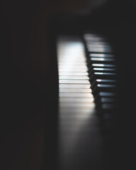 Vertical closeup shot of the piano keyboards in the dark