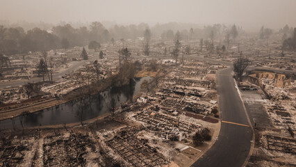 Smoke filled skies overlooking the aftermath and tragedy of a wildfire that blew through small town