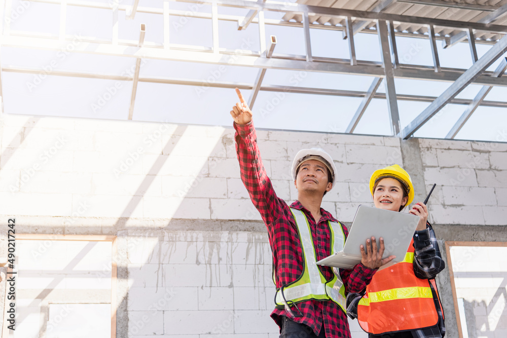 Poster asian engineer foreman worker man and woman working at building construction site use laptop and tal