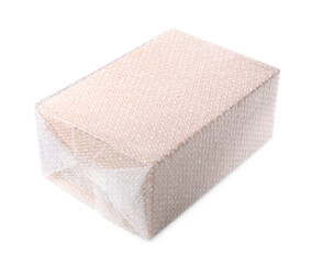 Cardboard box packed in bubble wrap isolated on white