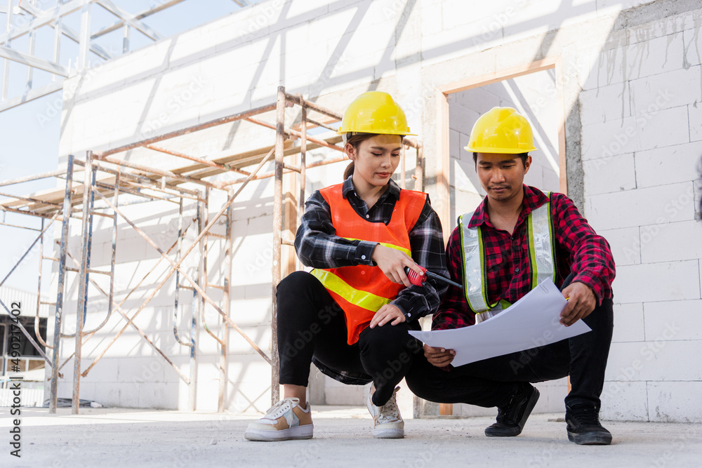 Poster architect and client discussing help create plan with blueprint of the building at construction site