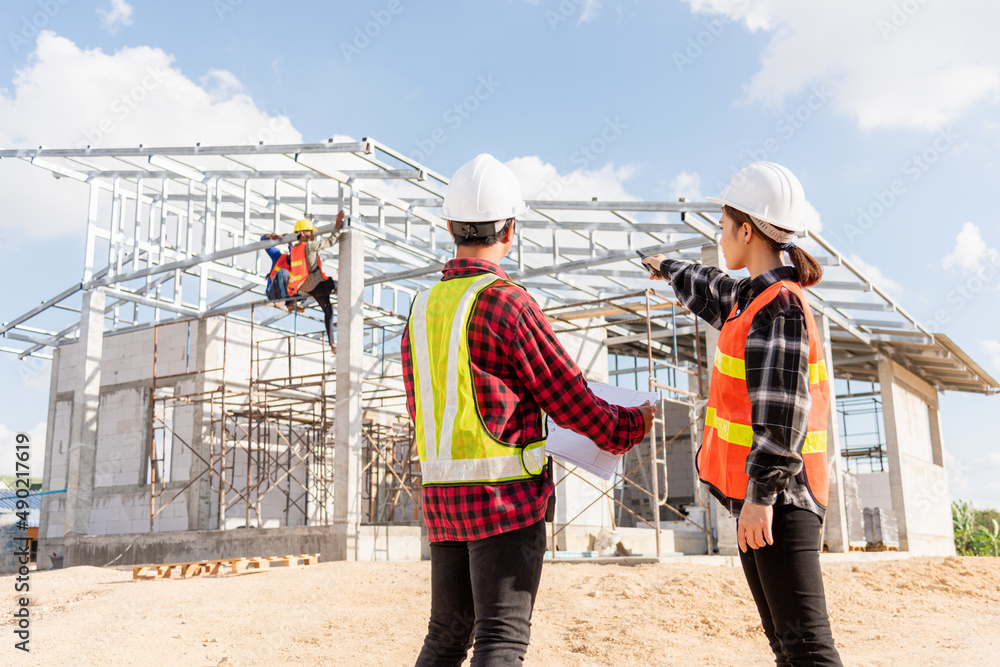 Poster back two architect and client discussing help create plan with blueprint home building at constructi