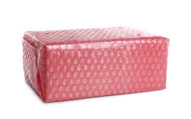 Cardboard box packed in red bubble wrap isolated on white