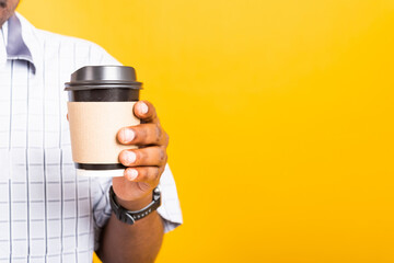 Asian happy portrait young business black man holding a paper coffee cup to take away, studio shot isolated on white background