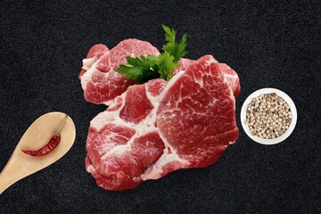 Raw beef rib eye steak prepared for grilling with seasonings and herbs. Fresh meat steak