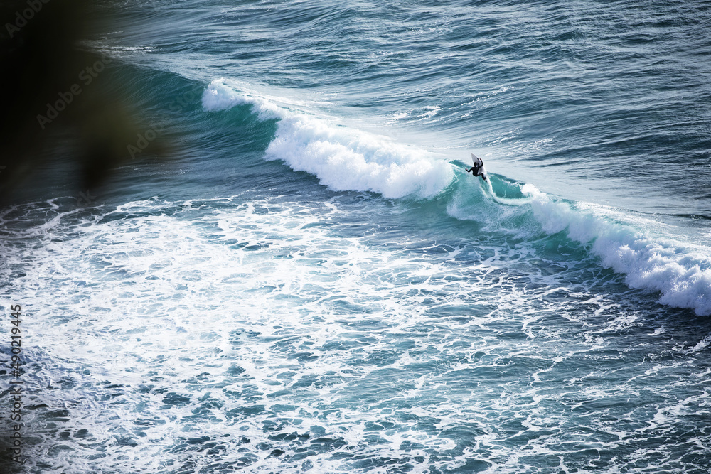 Sticker Beautiful shot fo the surfer riding the wave, Portugal