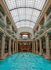 Group of people swimming in an indoor pool at Gellert spa in Budapest, Hungary