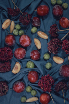 Vertical Shot Of Different Fruits And Flower On A Blue Table Mat