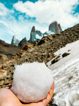 Man holding a snowball in Mount Fitz Roy, El Chalten, Argentina