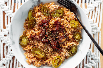 vegan ginger noodles with sundried tomatoes and jalapenos topped with coriander seeds and herbs, healthy plant-based food