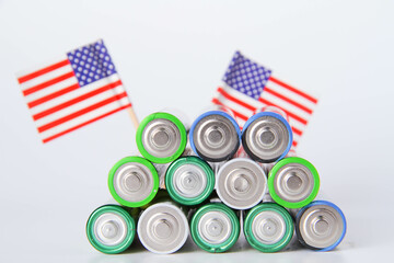 Battery. A lot of batteries on the background of the flag of the country.