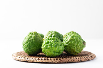 Organic Kaffir lime, Citrus fruit used in Southeast Asian cuisine and essential oil on white background