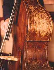 Concert view of an old retro vintage contrabass violoncello  player with vocalist and musical band...
