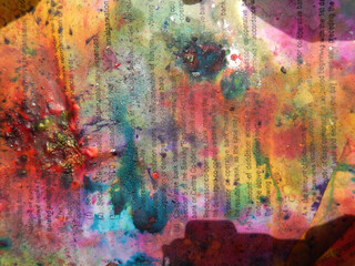 Papers on the ground covered with colors, celebrating the Holi Hindu festival in Lord Krishna Temple