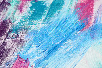 Naklejka premium Strokes of colorful acrylic paints on white canvas, closeup