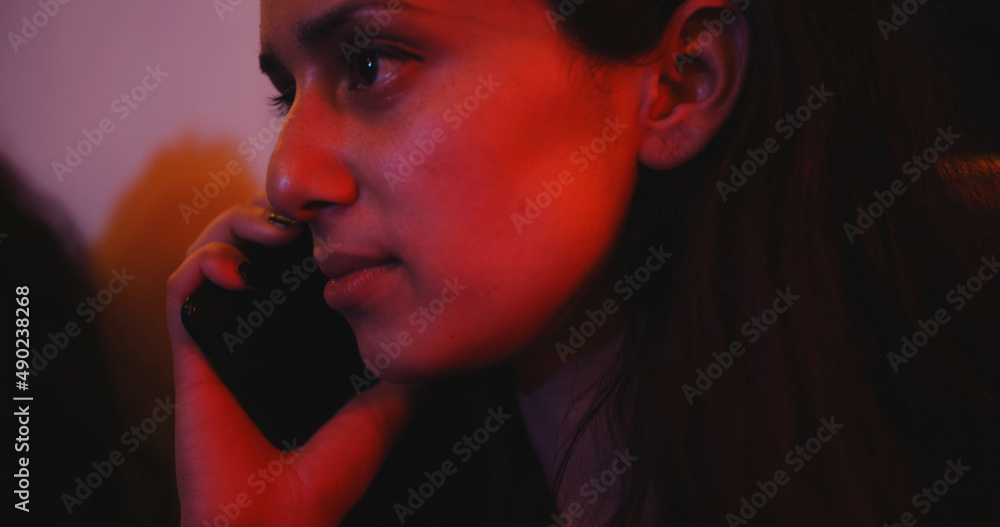 Poster South Asian female talking on the phone on a blurred background