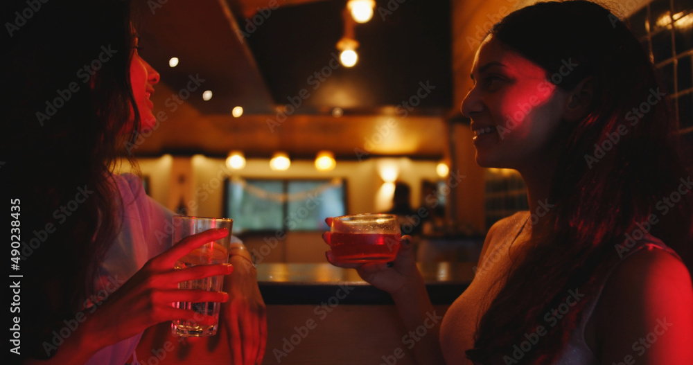 Wall mural South Asian female friends at a party having drinks