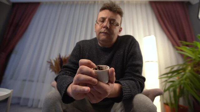 Fortune teller is telling fortunes.
He looks at the coffee fortune of the person standing in front of him. The fortune teller interprets and explains.
