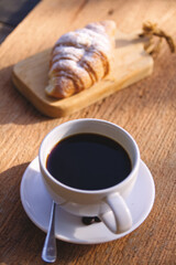 cup of coffee with croissant