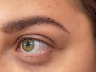 closeup of a beautiful intense yellow eye. yellow woman eye