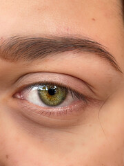 closeup of a beautiful intense yellow eye. yellow woman eye