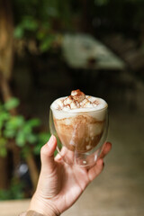 Woman hands  holding cup of coffee with latte art. holding cup of tea or coffee in the morning