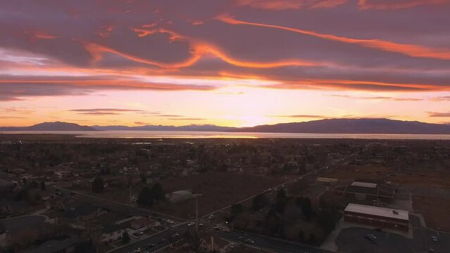 Colorful patterns in the sky at sunset over Orem looking towards Utah Lake from aerial view.