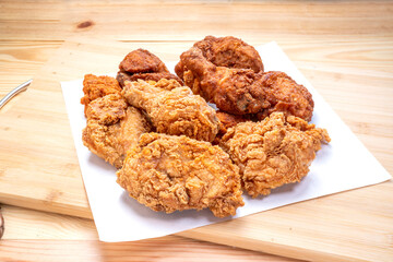Fried chicken on wooden background.