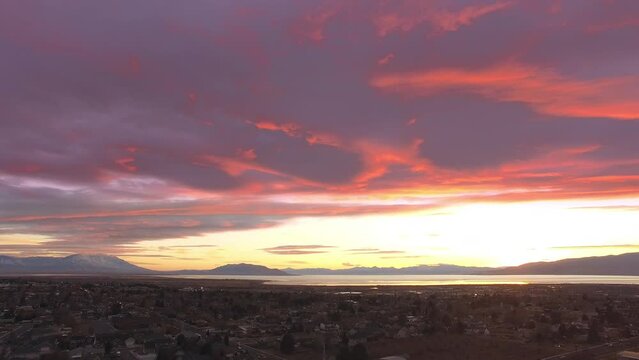 Aerial view over Utah Valley during colorful sunset over the city of Orem.