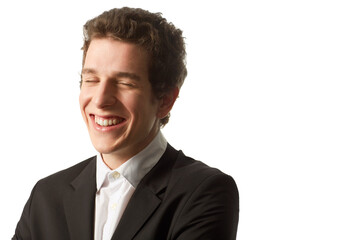 Sincere smile. A young man wearing a buttoned up shirt and jacket laughing as he stands against a white background.