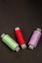 The threads are multicolored. Spools of thread.