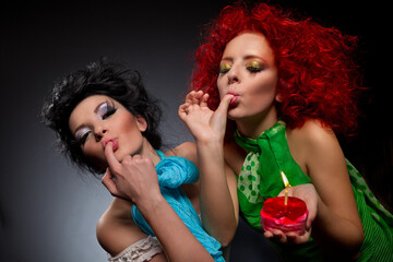 Two glamour girls with cake.