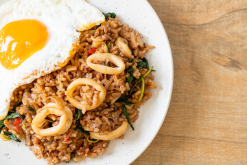 fried rice with squid and basil topped fried egg in Thai style