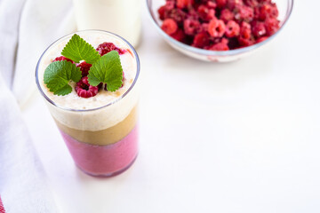 Delicious layered yogurt dessert with applesauce, raspberries and banana.