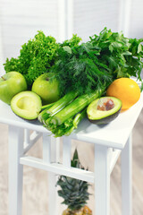 Vegetables and fruits closeup. The concept of healthy eating. Avocado, apples, celery, herbs, pineapple. Detox program. High quality photo
