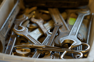 Tossed flat keys in a plastic box.