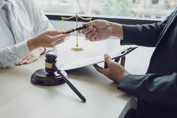 A man lawyer or a judge counseling clients about judicial justice and prosecution with scales,...