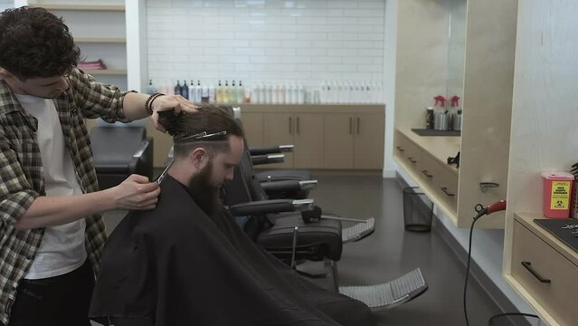 Barber balances a blend to skin with scissors on undercut hair style