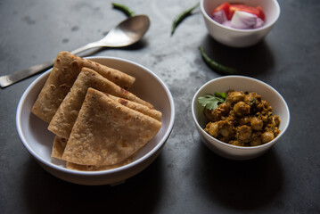 Popular Indian meal paratha or flat bread and chana or chick pea masala. Close up. 