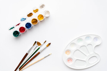 Flat composition set of artistic tools. Brushes, paints, pencils, pastels for drawing. Place for text.