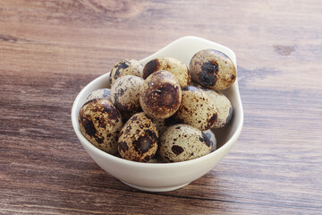 Raw quail eggs heap in the bowl
