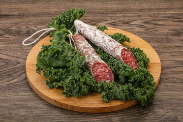 Spanish Fuet sausage with salad leaves