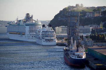 Modern big cruiseship or cruise ship liner in port of Quebec City, Canada with Chateau Frontenac...